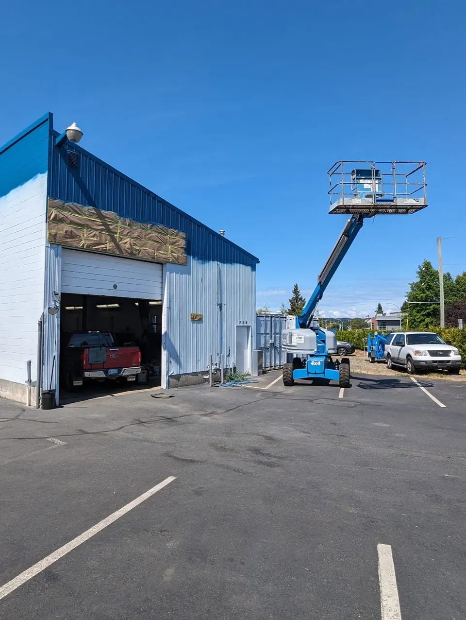 Boom lift beside the shop during painting
