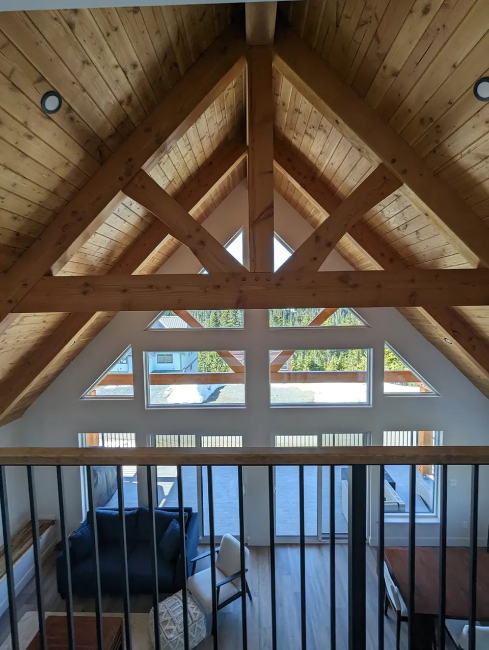 Stained timber trusses over tall windows